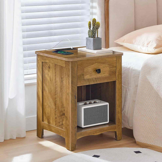 Wooden nightstand with a radio and small plant next to a bed with white bedding.