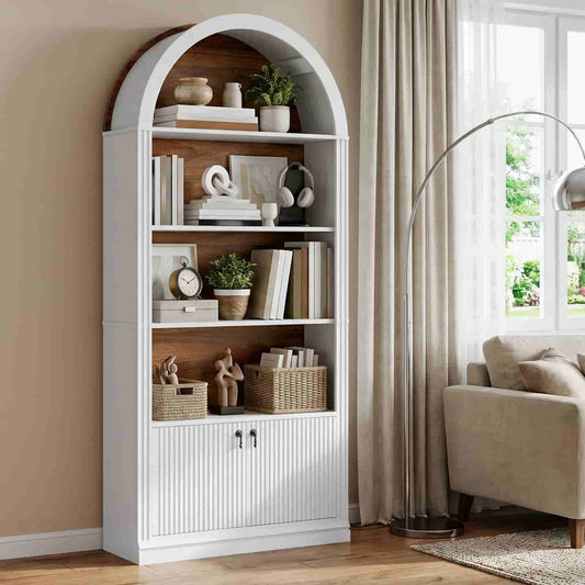 Elegant white arched bookshelf with a rustic brown wood back panel styled with books and decor in a living room.