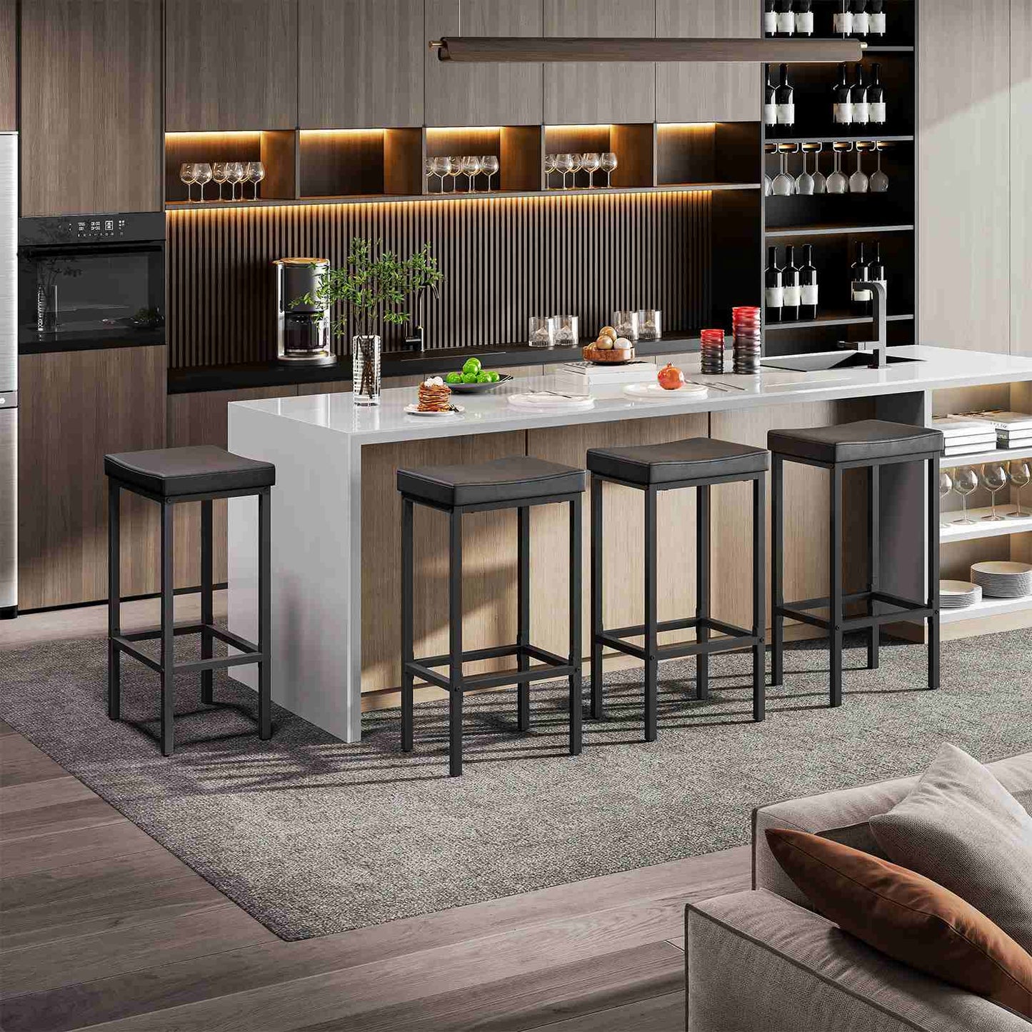 Set of 4 modern black pub height dining chairs styled at an open home bar area next to a living room.