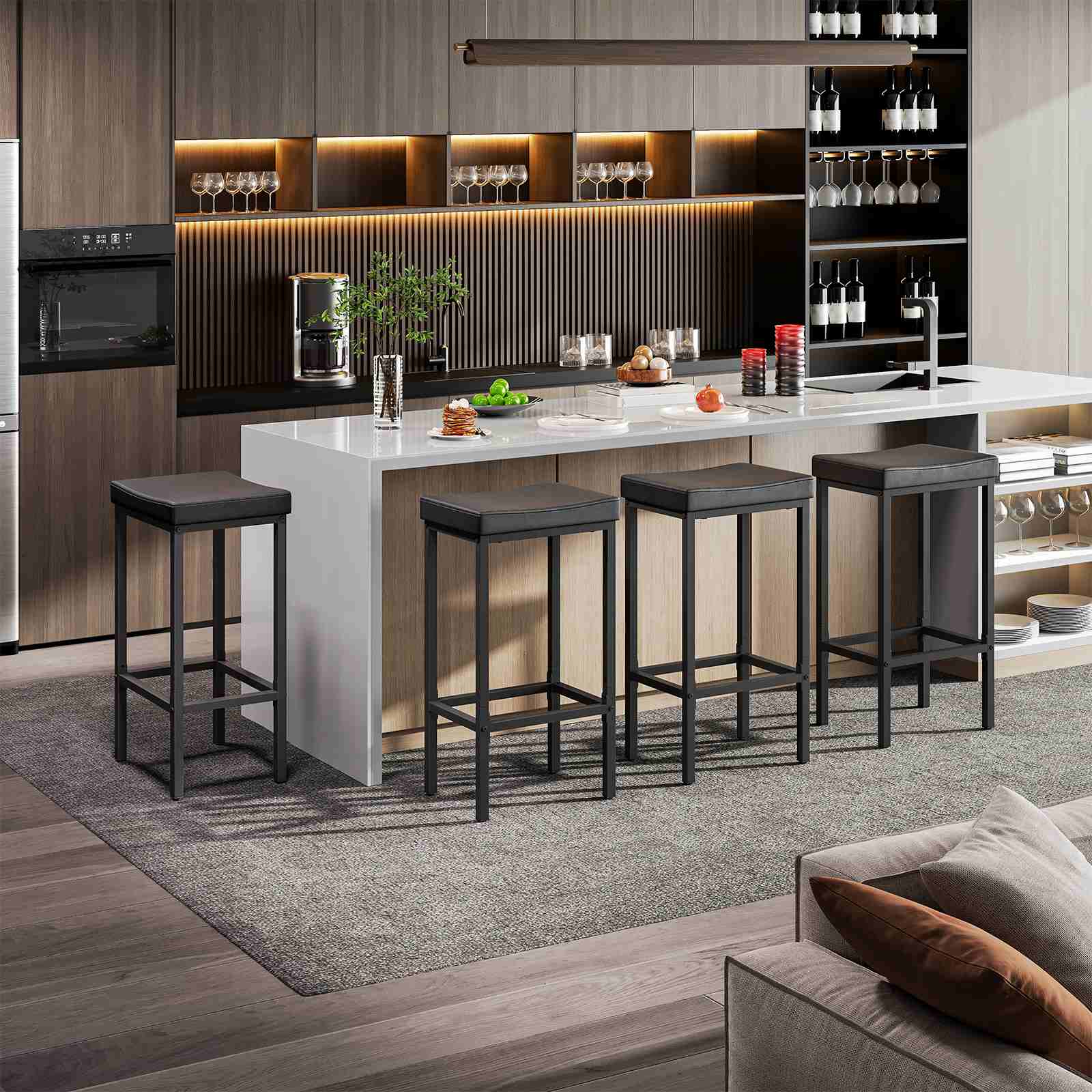 Set of 4 modern black pub height dining chairs styled at an open home bar area next to a living room.