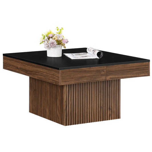 Modern square wood coffee table featuring a black tabletop and fluted walnut base styled with a flower vase.