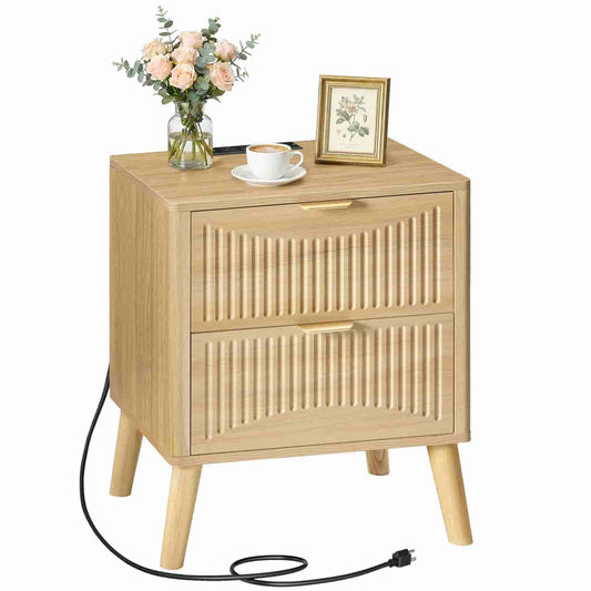 Studio shot of a natural wood bedside table with power strip, usb ports, and decorative flower vase on top.