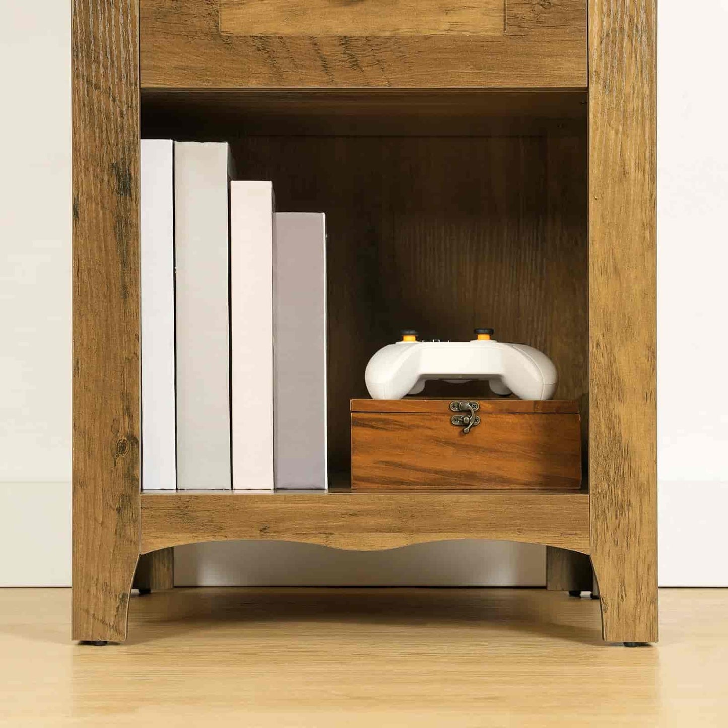 Wooden cabinet with books and a decorative box inside