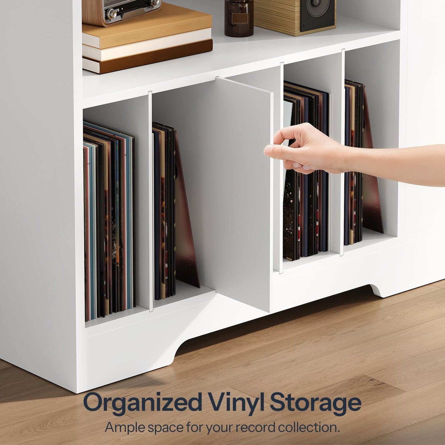 Close up of a hand pulling an album from the organized vertical vinyl storage slots with sturdy dividers.