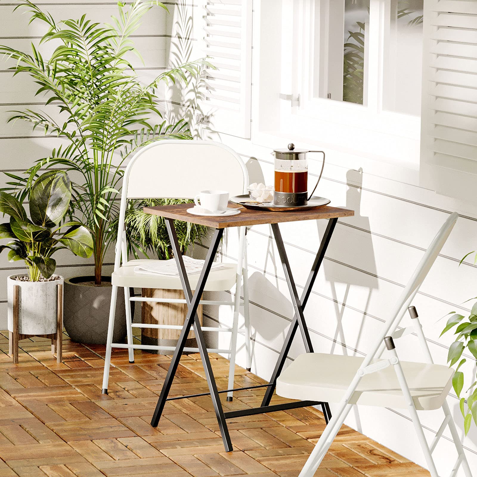 Portable outdoor patio folding table used as a bistro coffee table set with two white chairs.
