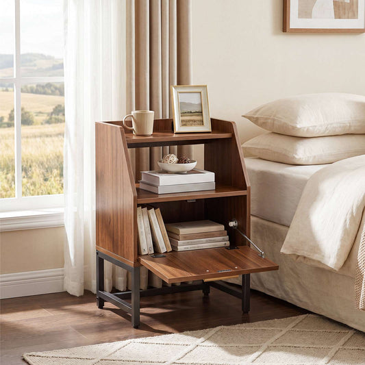 Rustic brown rattan nightstand with a flip-down door styled next to a bed holding books and a coffee mug.