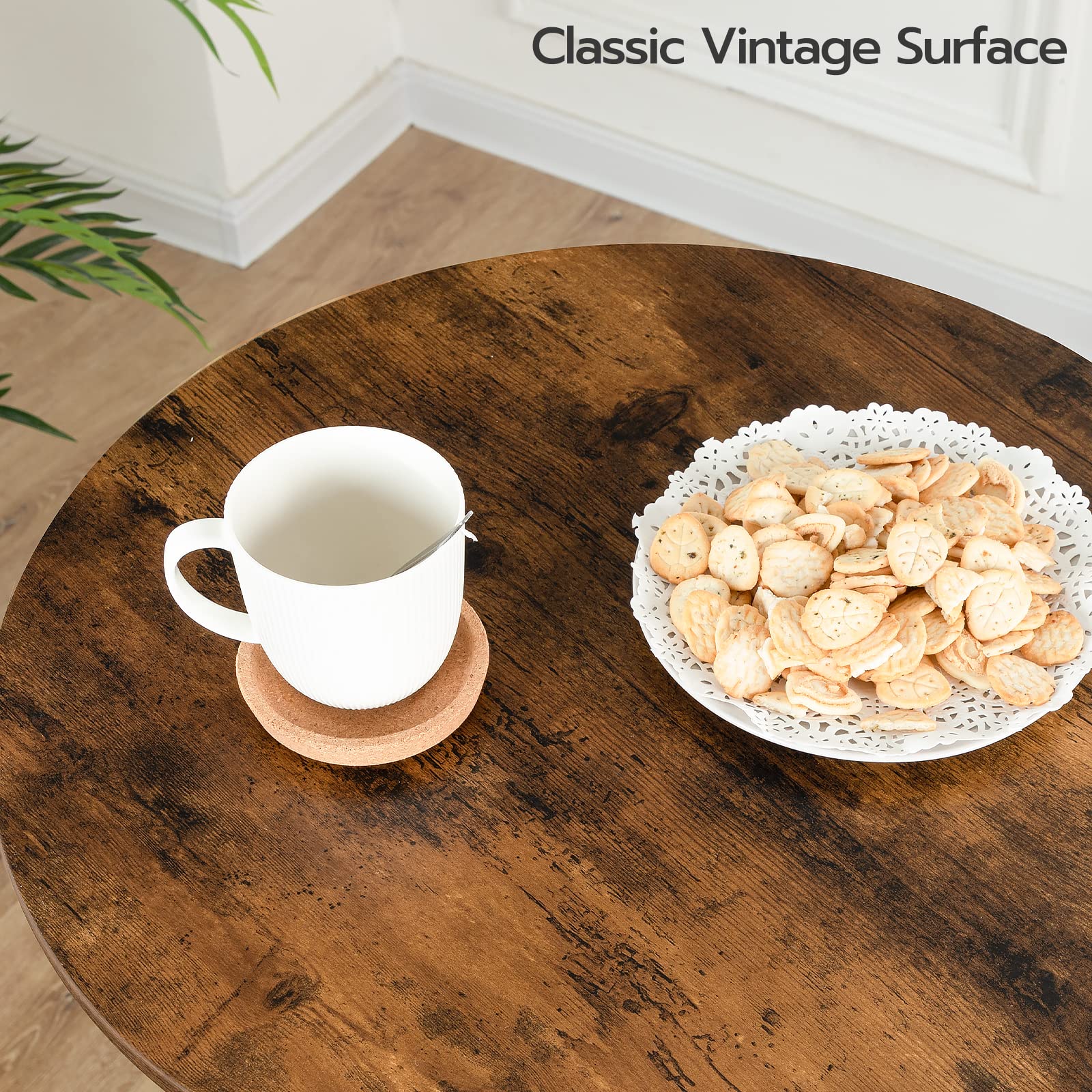 Close up of the rustic brown round tabletop with vintage wood grain finish holding a white coffee mug and snacks.