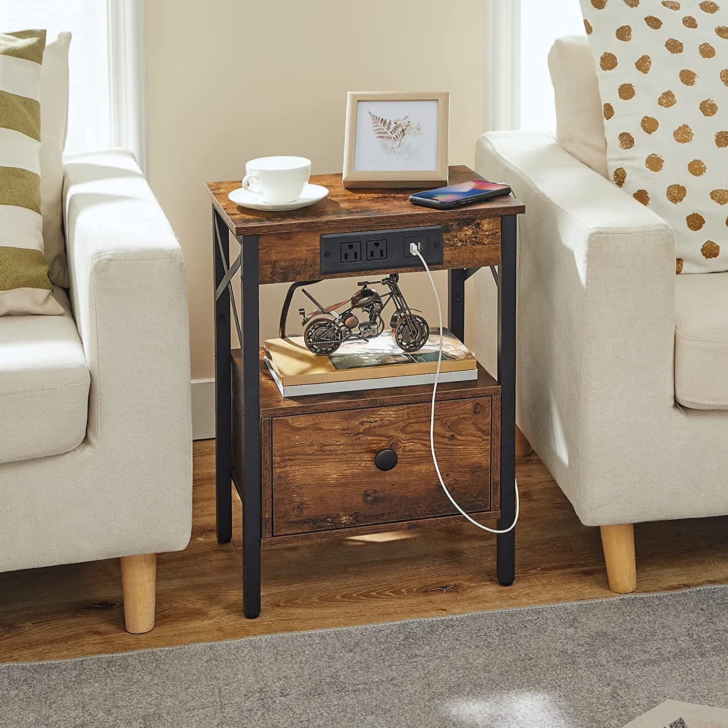Rustic industrial end table placed in a gap between two living room sofas, holding coffee cups.