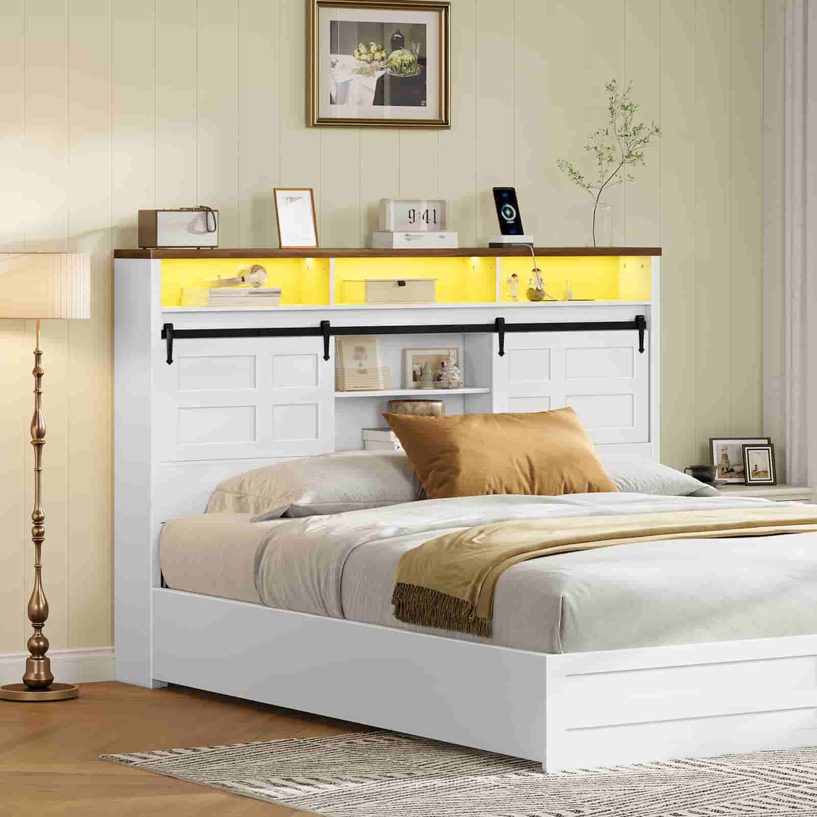 ozy bedroom setup showcasing the white farmhouse bookcase headboard styled with books and photo frames.