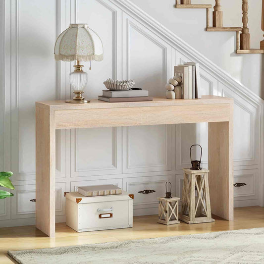 Light wooden console table with decorative items against a white paneled wall.