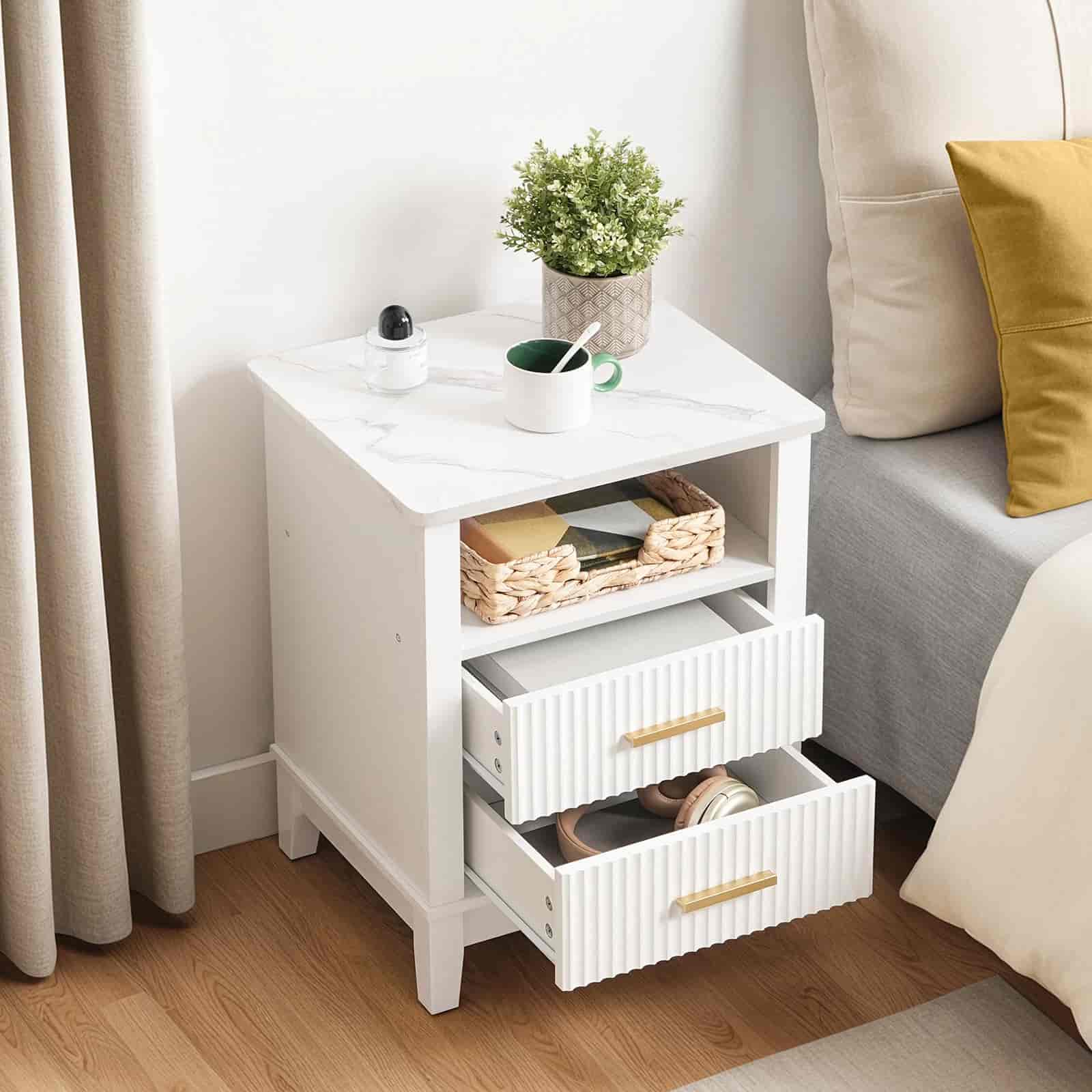 White nightstand with drawers in a bedroom setting