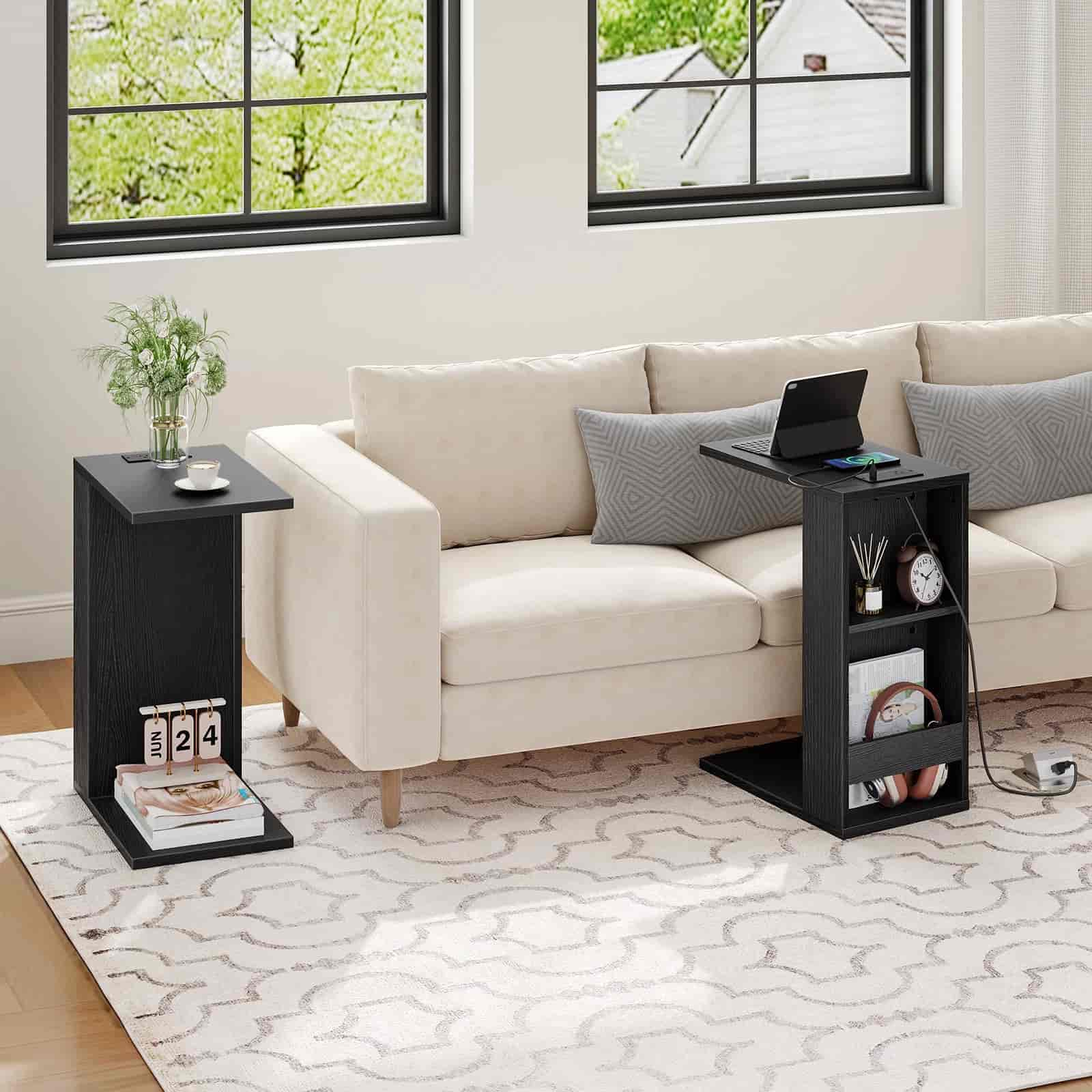 Beige sofa with two black side tables in a living room setting.
