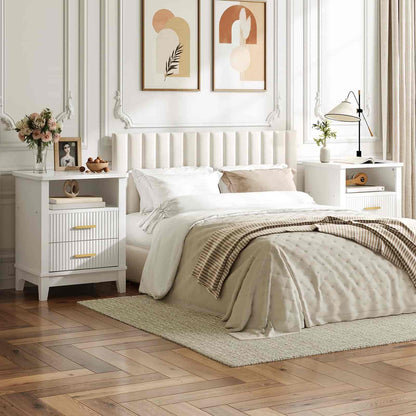Neatly made bed in a bedroom with white headboard and nightstands.