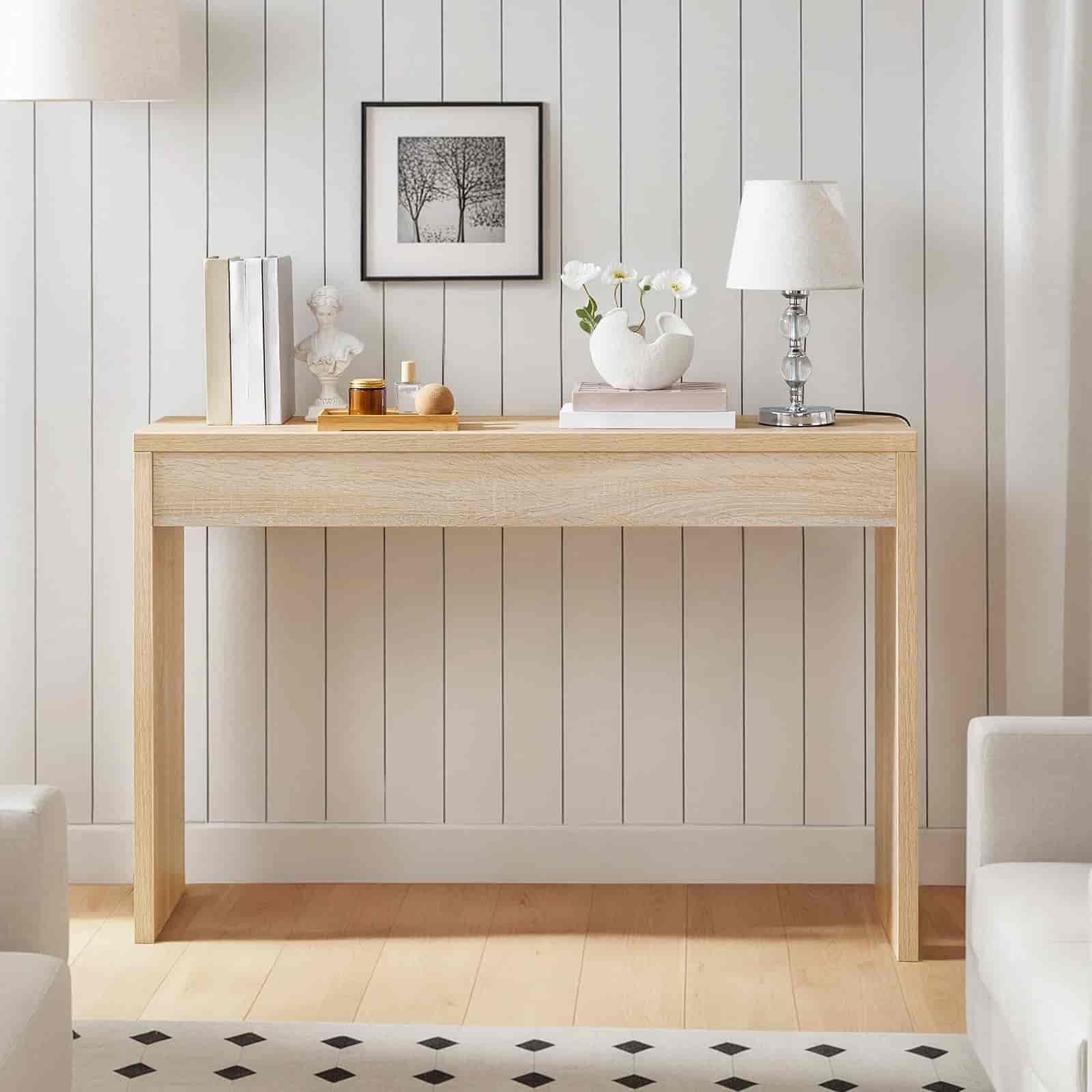 Wooden console table with decorative items against a white paneled wall.