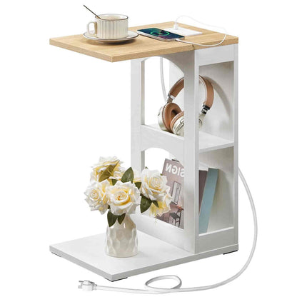 Small side table with wooden top and white shelves, featuring a cup, phone, headphones, and flowers.