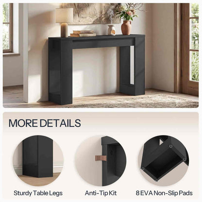 Black console table in a room with decorative items, featuring details of sturdiness and safety features.