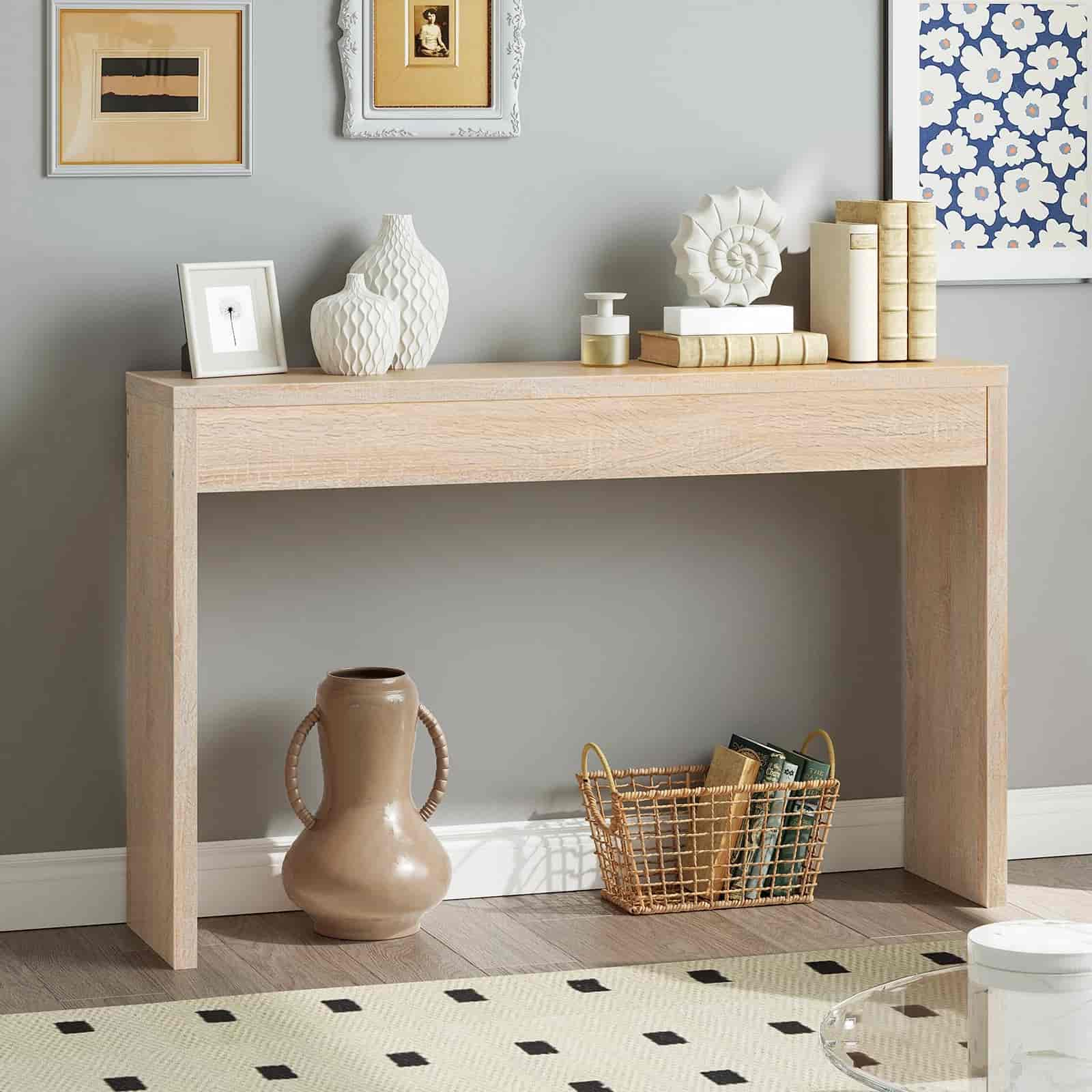 Wooden console table with decorative items against a gray wall