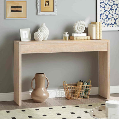 Wooden console table with decorative items against a gray wall