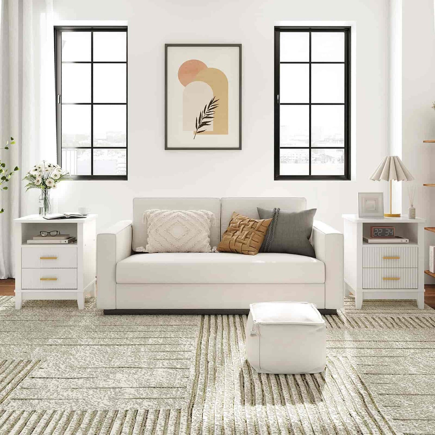 Modern living room with a gray sofa, white side tables, and abstract art on the wall.