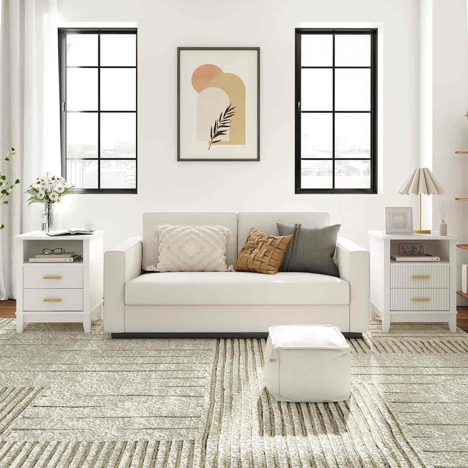 Modern living room with a gray sofa, white side tables, and abstract art on the wall.