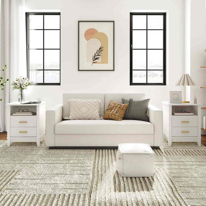 Modern living room with a gray sofa, white side tables, and abstract art on the wall.