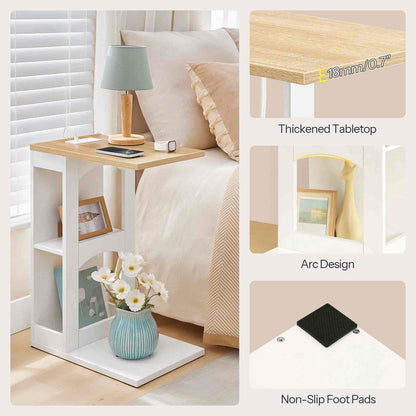 Small side table with shelves next to a bed, featuring a lamp, phone, and vase.