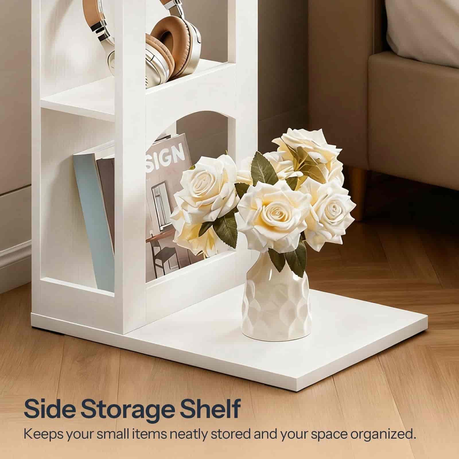 White side storage shelf with a vase of flowers and small items on a wooden floor.