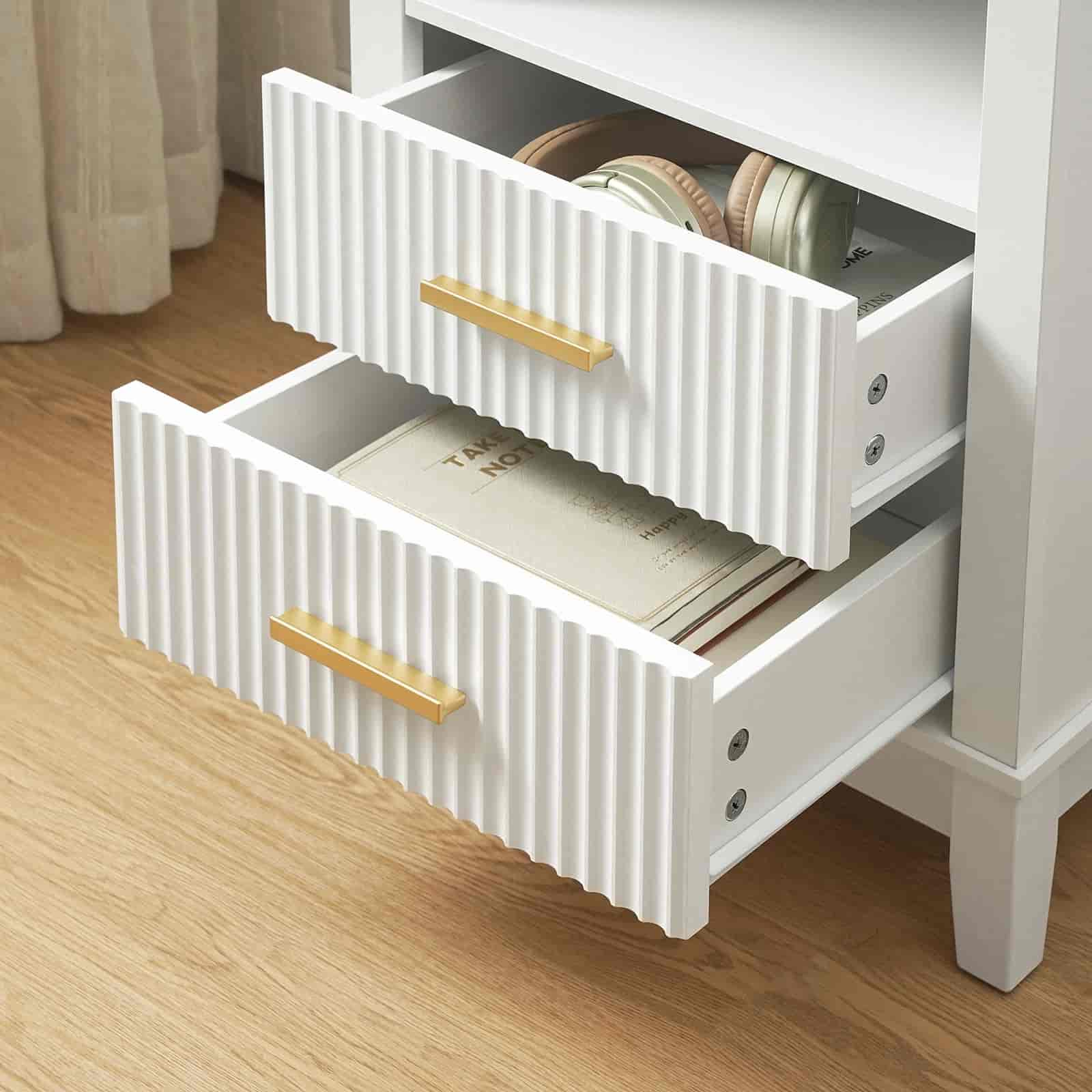 White dresser with open drawers on a wooden floor
