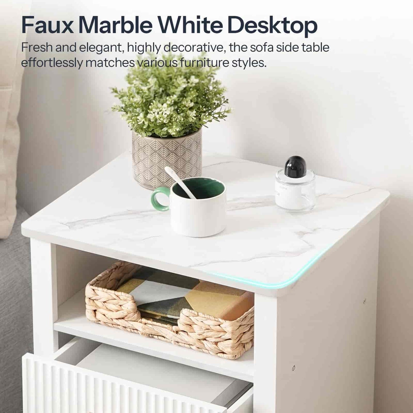 Faux marble white desk with a plant, mug, and basket on top in a room setting.