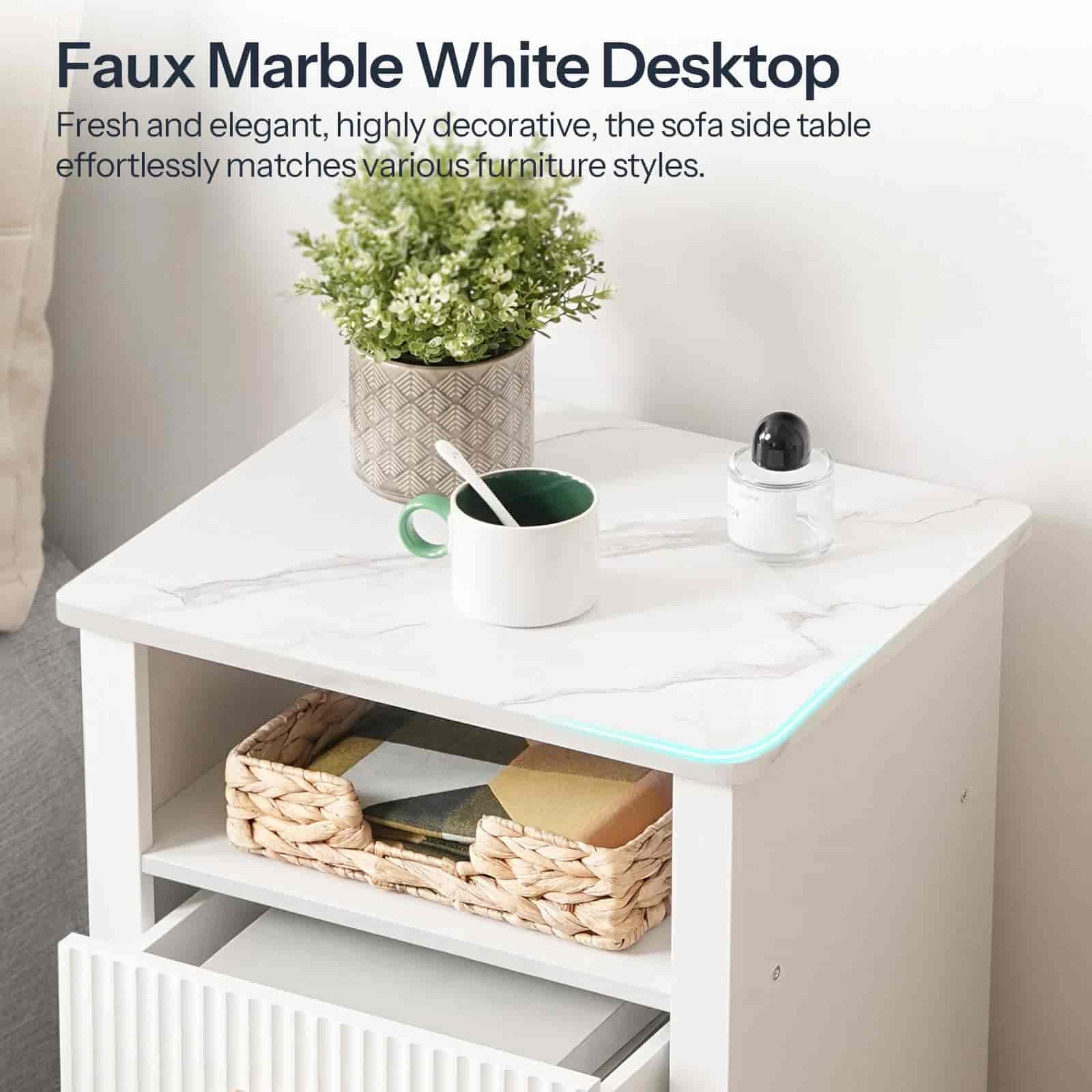 Faux marble white desk with a plant, mug, and basket on top in a room setting.