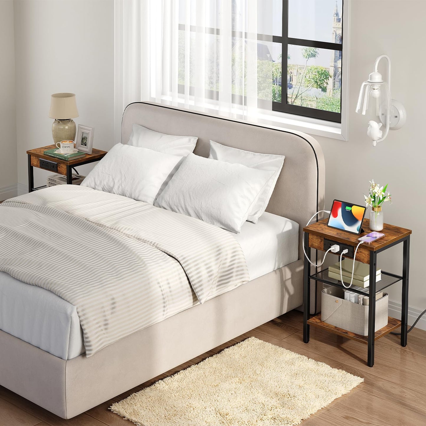 Neatly made bed with white bedding in a bright bedroom with a nightstand and lamp.