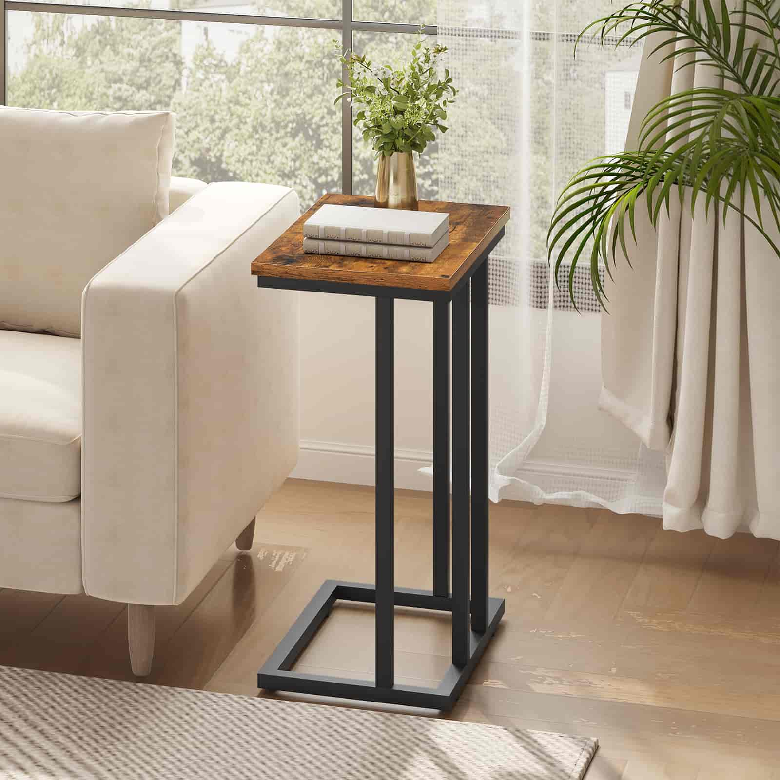 Small wooden side table with black metal legs in a living room setting.
