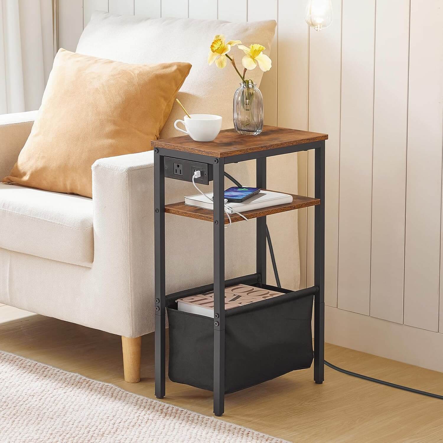 Small wooden side table with a black metal frame next to a white sofa with a yellow pillow.