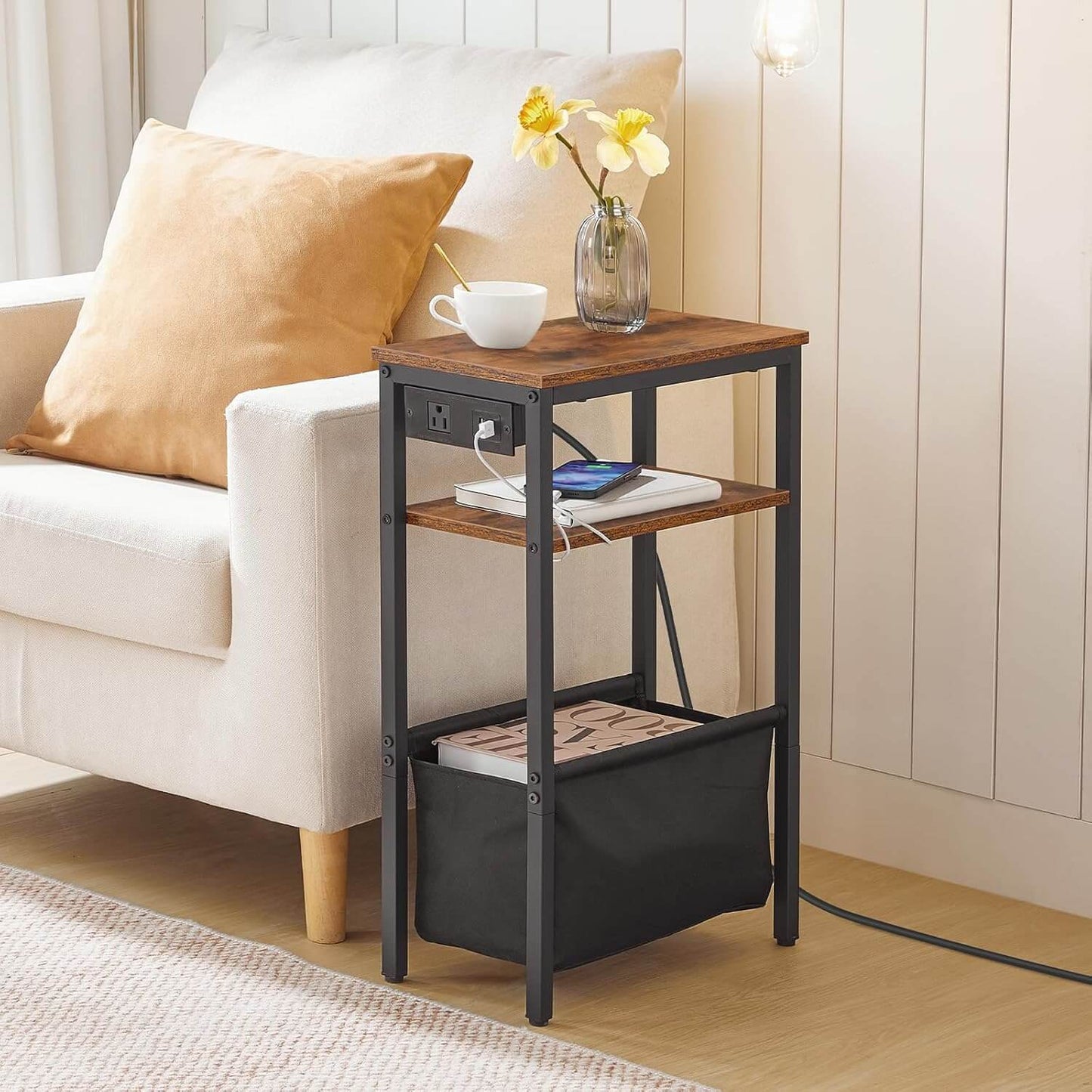 Small wooden side table with a black metal frame next to a white sofa with a yellow pillow.