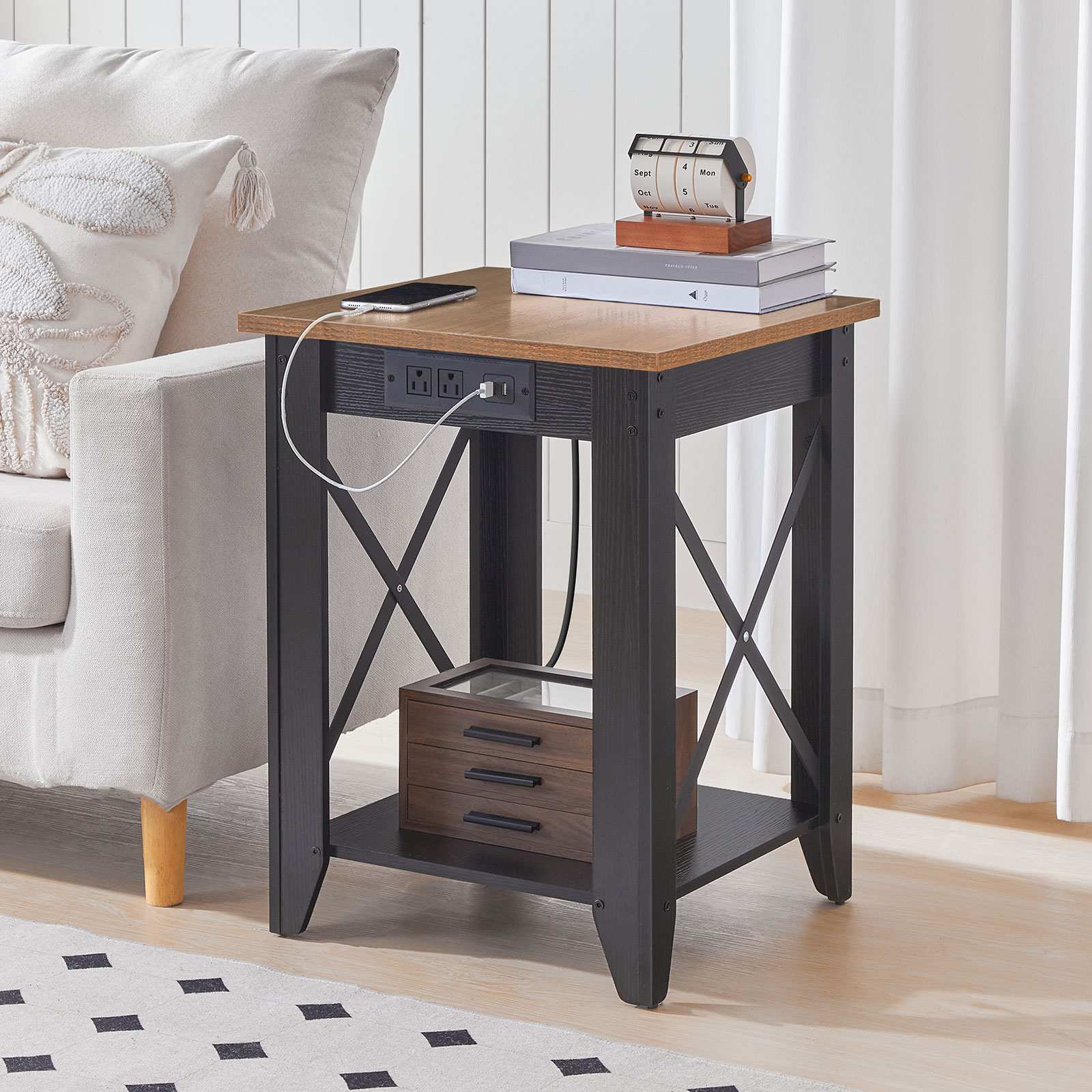 Close-up of the rustic brown square side table with its integrated power outlet block being utilized right next to a modern living room couch.
