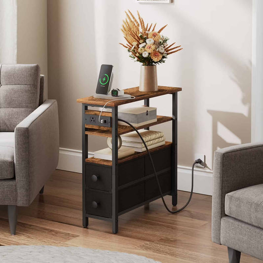  Industrial narrow end table with charging station and a vase of flowers placed between two grey armchairs