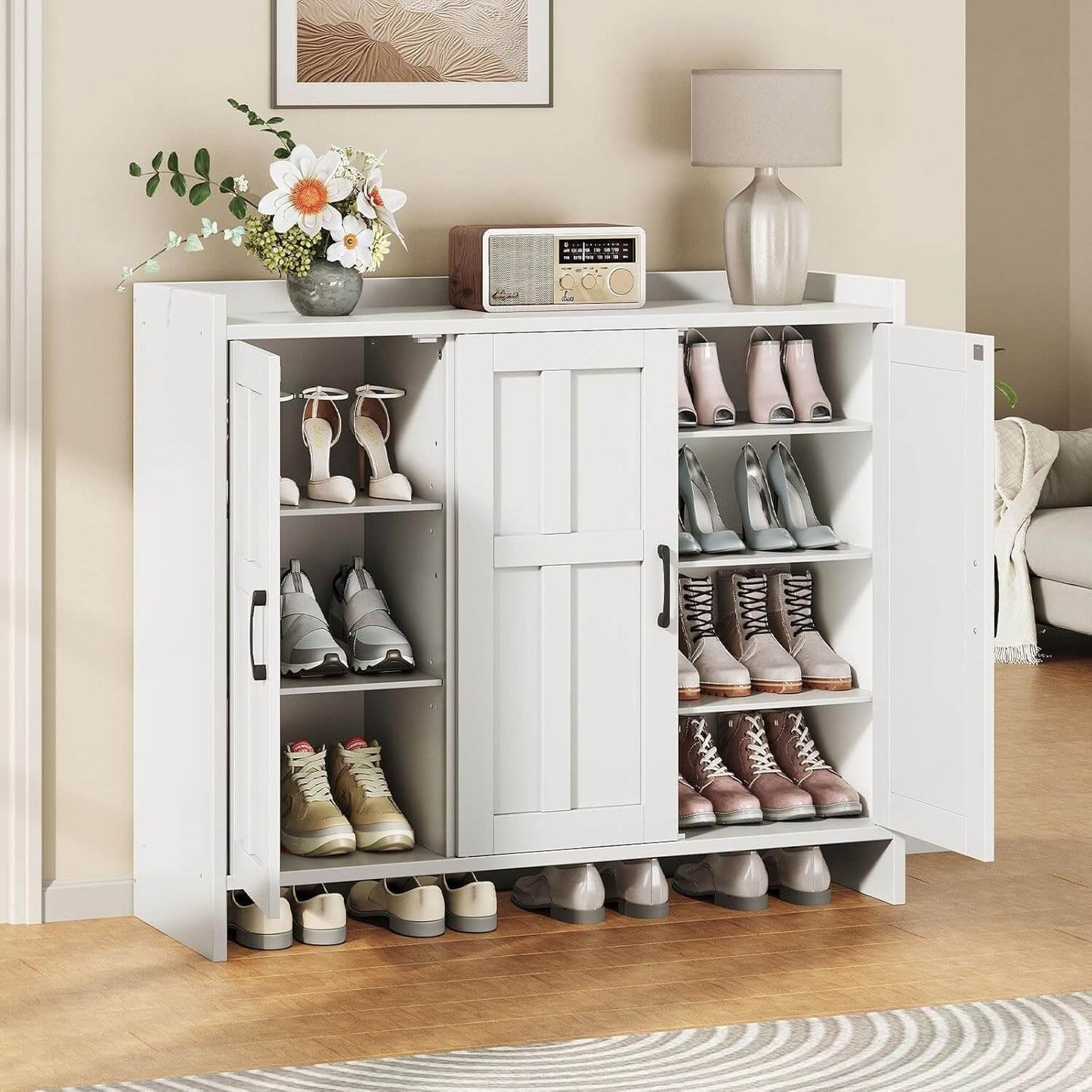 White shoe cabinet with open doors displaying various shoes in a room setting.