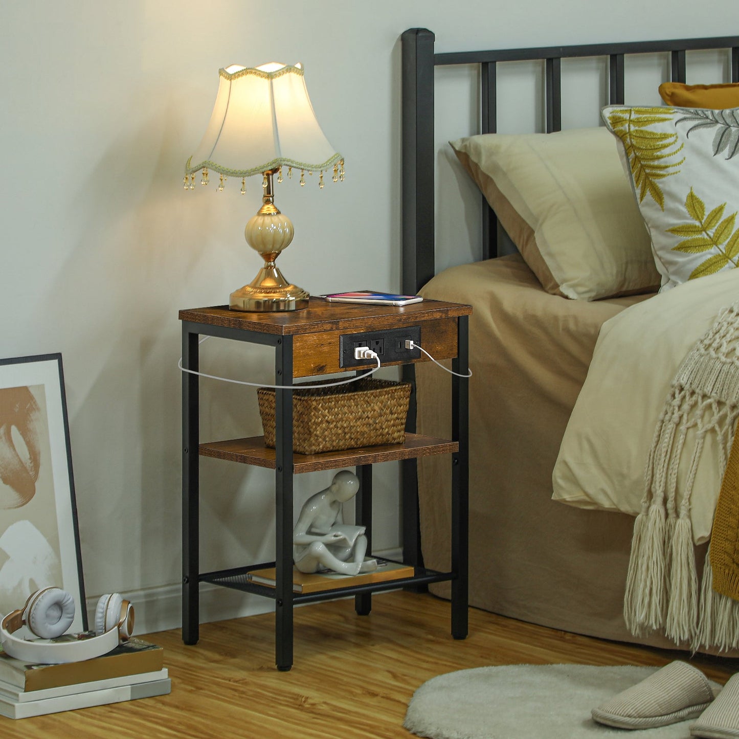 Small bedside table with an embedded power strip glowing next to a bed in a warm bedroom.
