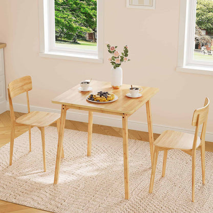 Natural bamboo square dining table styled on a woven rug with two matching chairs in a dining area.