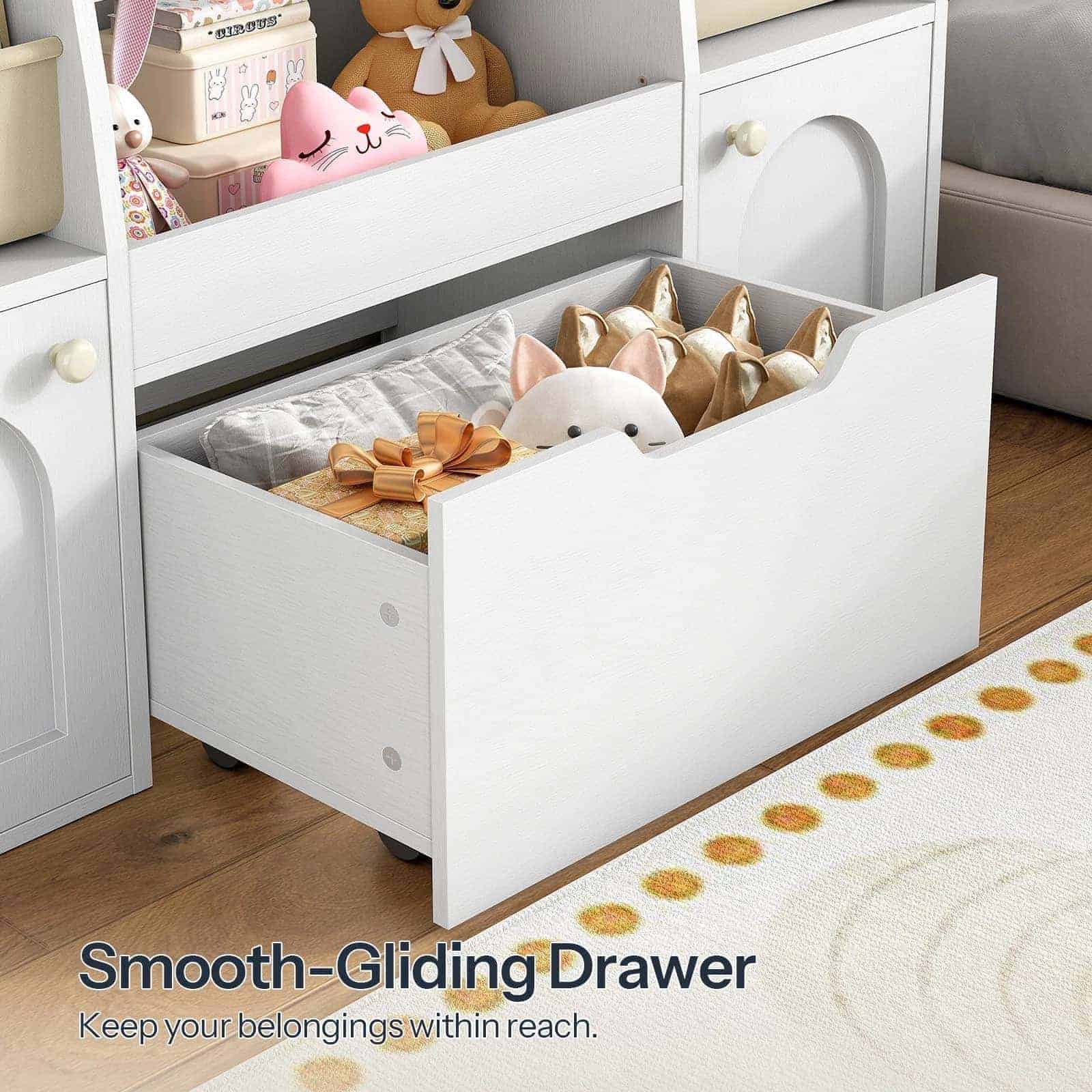 Close-up of the large smooth-gliding bottom drawer pulled open and filled with teddy bears.