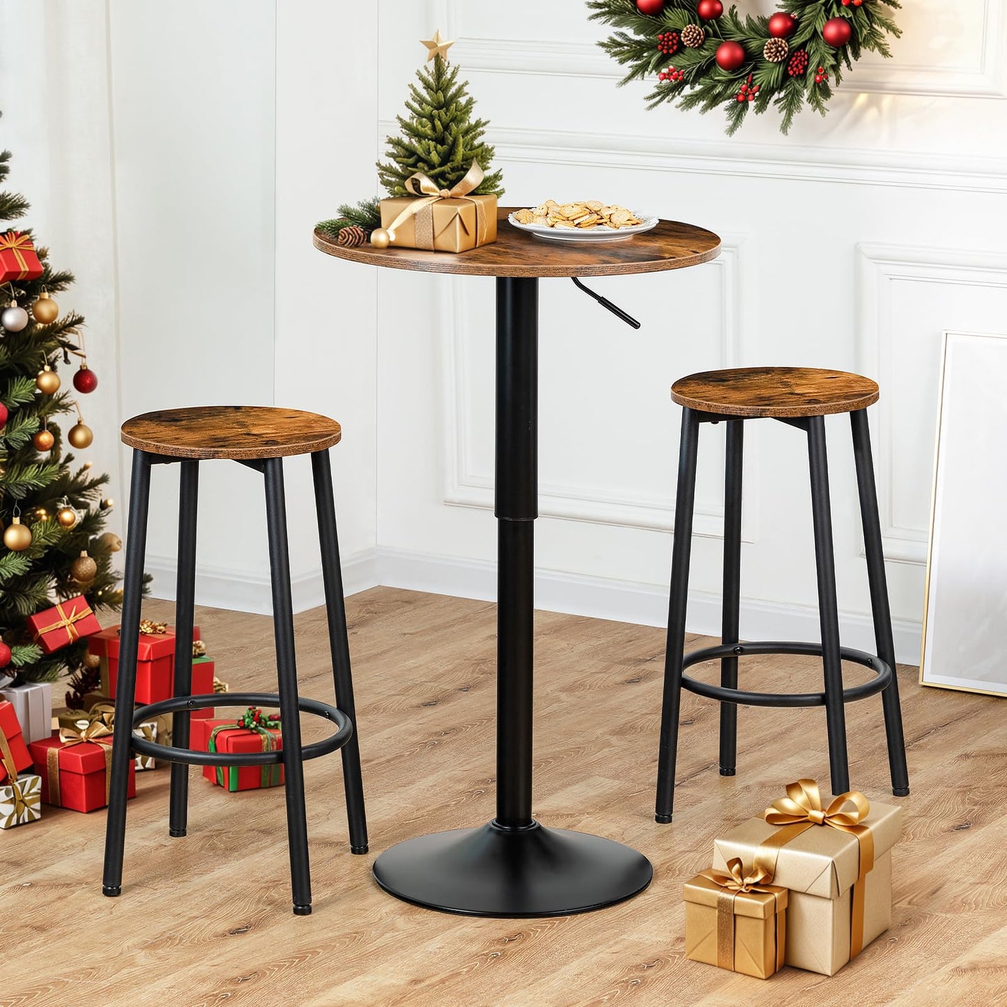Industrial swivel cocktail table set with two matching bar stools placed next to a Christmas tree with gifts.