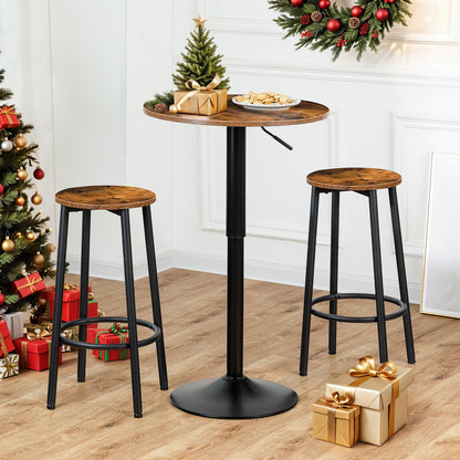 Industrial swivel cocktail table set with two matching bar stools placed next to a Christmas tree with gifts.