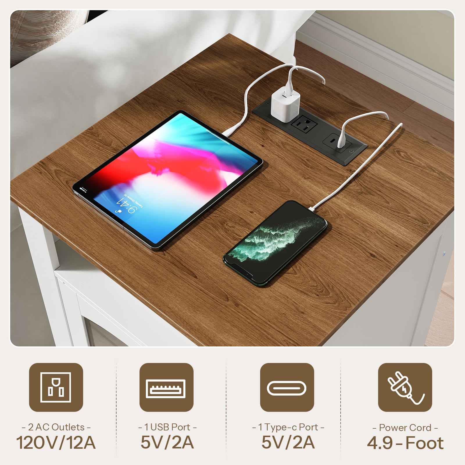 Wooden desk with electronic devices and power outlets, including a tablet and smartphone.