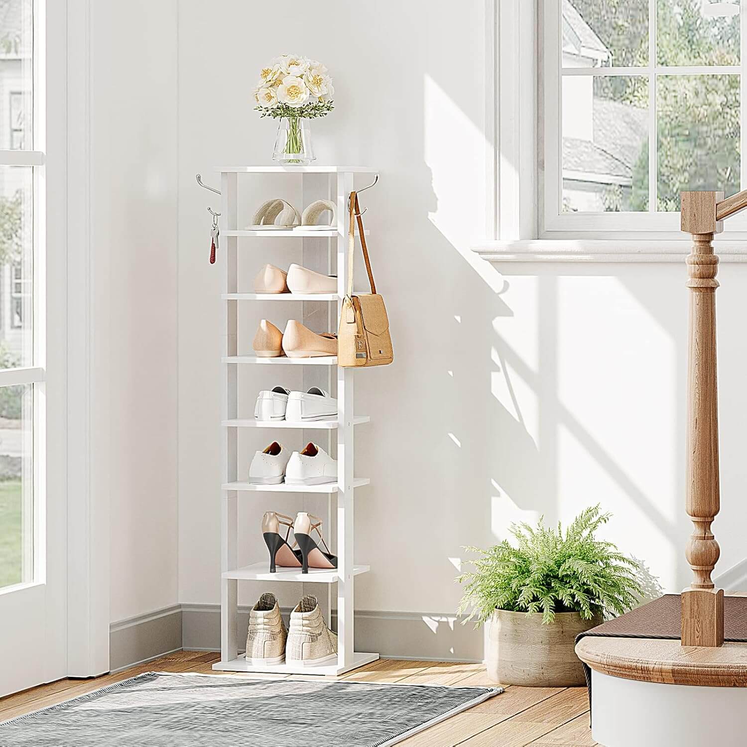 Shoe rack with shoes and a bag in a bright room with a window and plant.