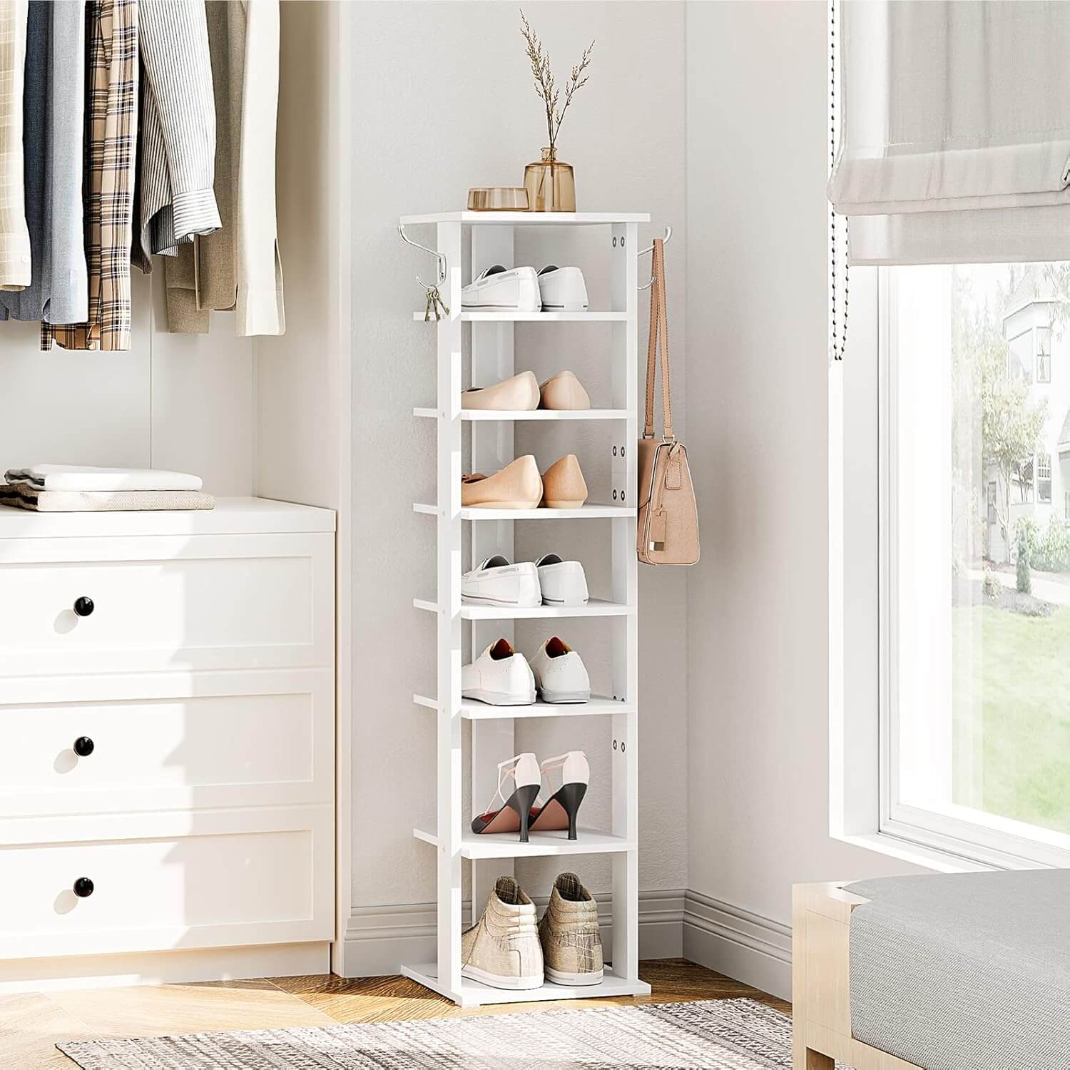 White shoe rack with shoes in a room with a dresser and window.
