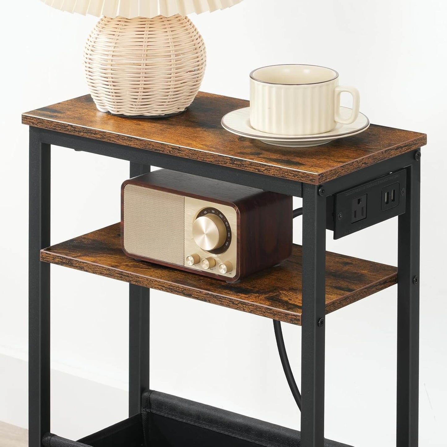 Small wooden side table with a radio, lamp, and cup on a white background