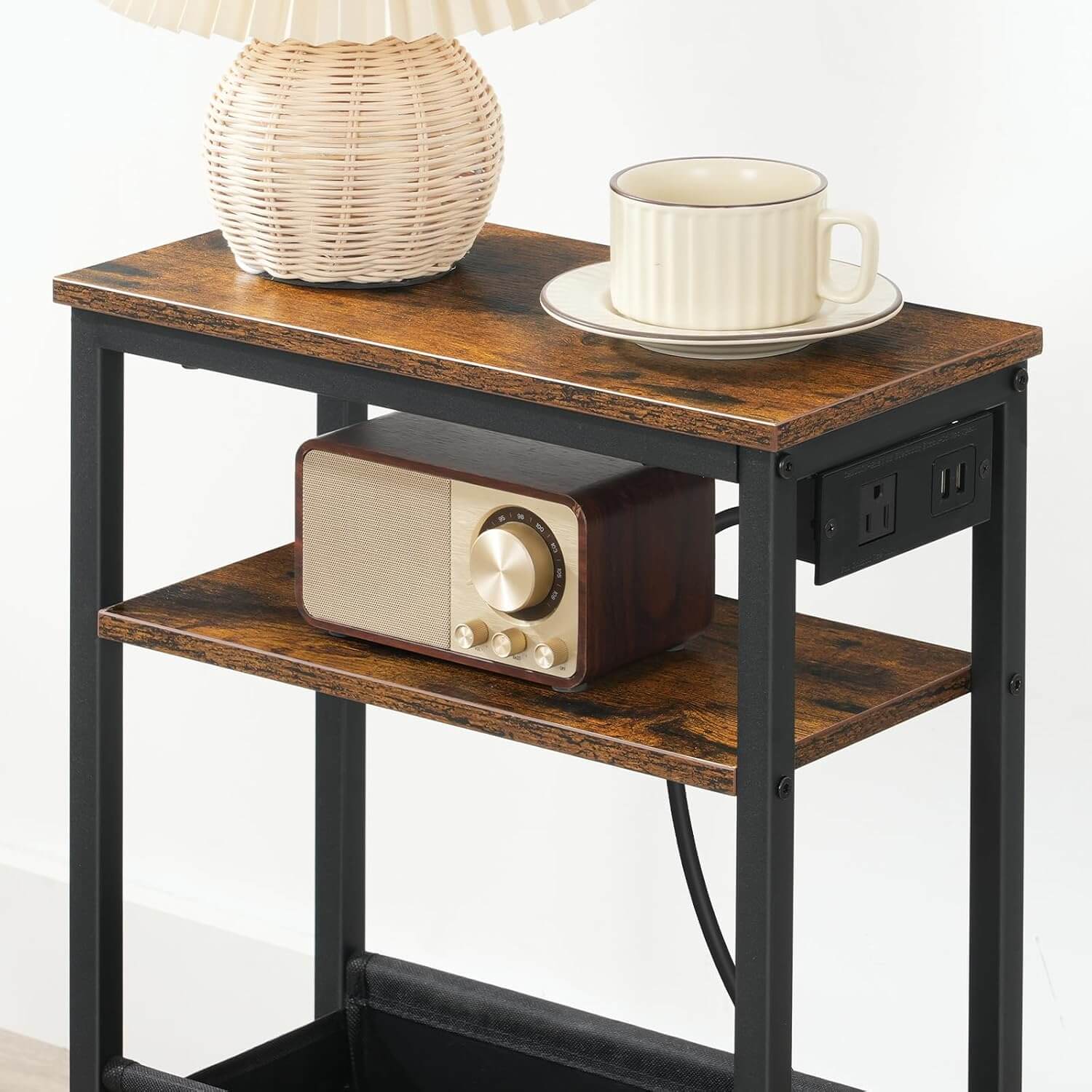Small wooden side table with a radio, lamp, and cup on a white background