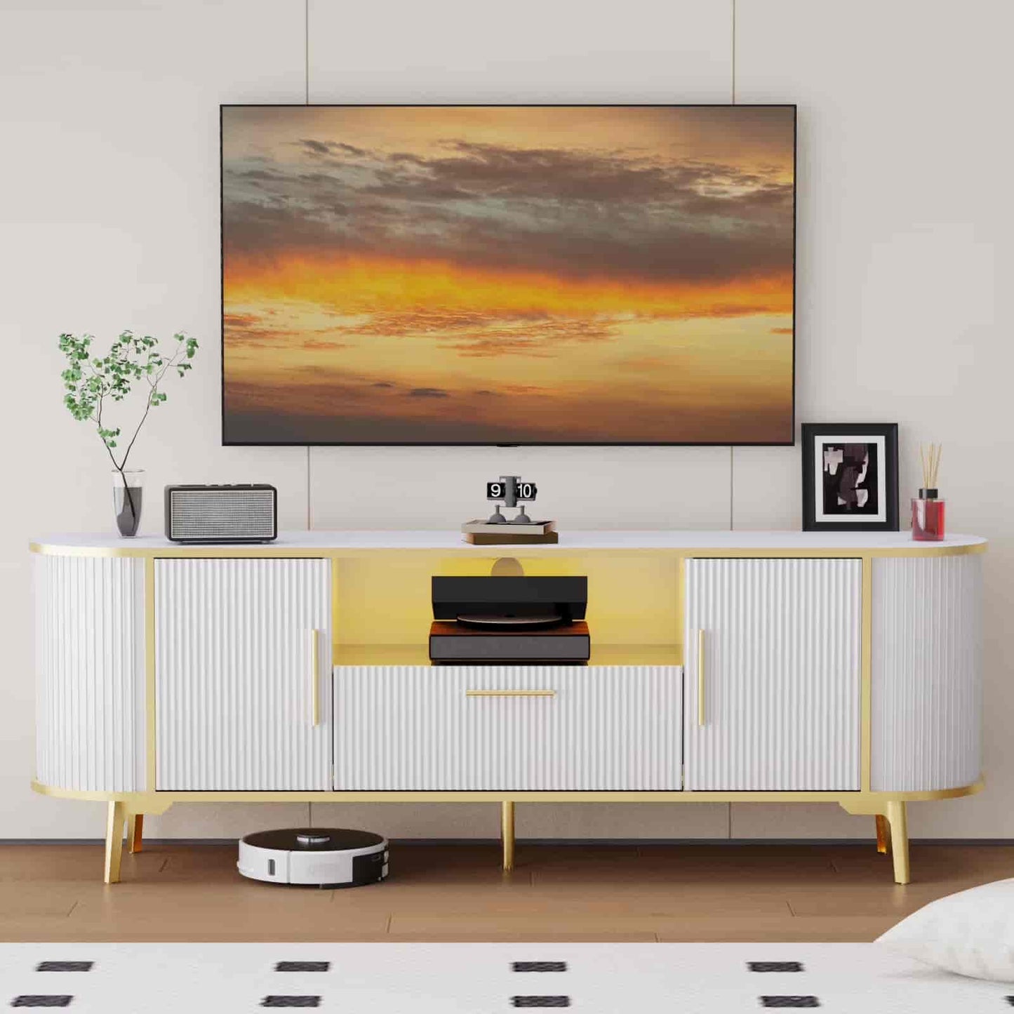 Modern living room with a TV displaying a sunset, a white and yellow sideboard, and decorative items.