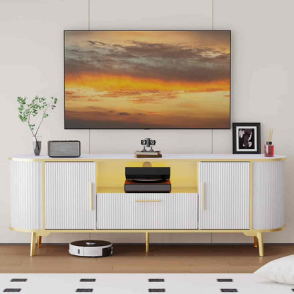 Modern living room with a TV displaying a sunset, a white and yellow sideboard, and decorative items.