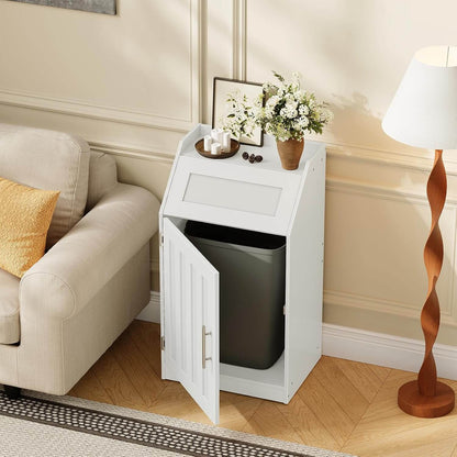 White trash bin cabinet with a black trash bin inside, placed in a living room setting.